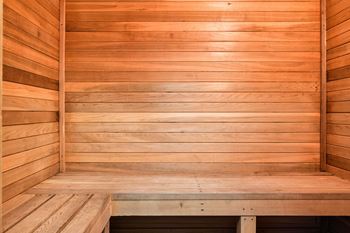 an empty sauna with wooden walls and benches